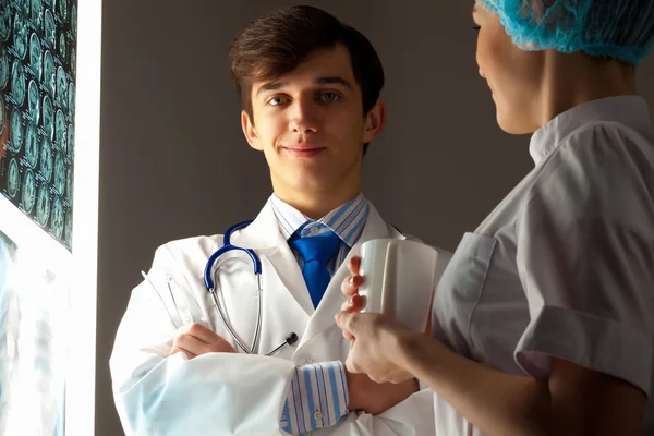 Two doctors examining x-ray results — Stock Photo, Image