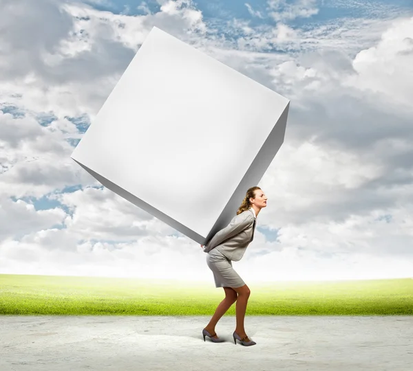 Businesswoman carrying cube — Stock Photo, Image