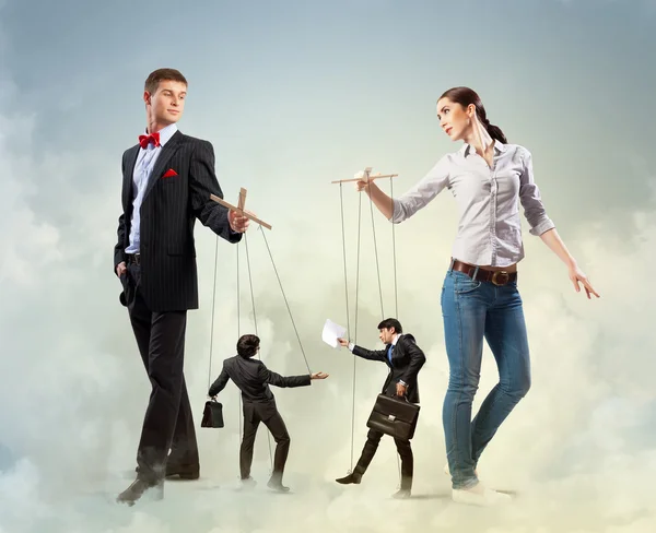 Businesspeople with marionettes — Stock Photo, Image