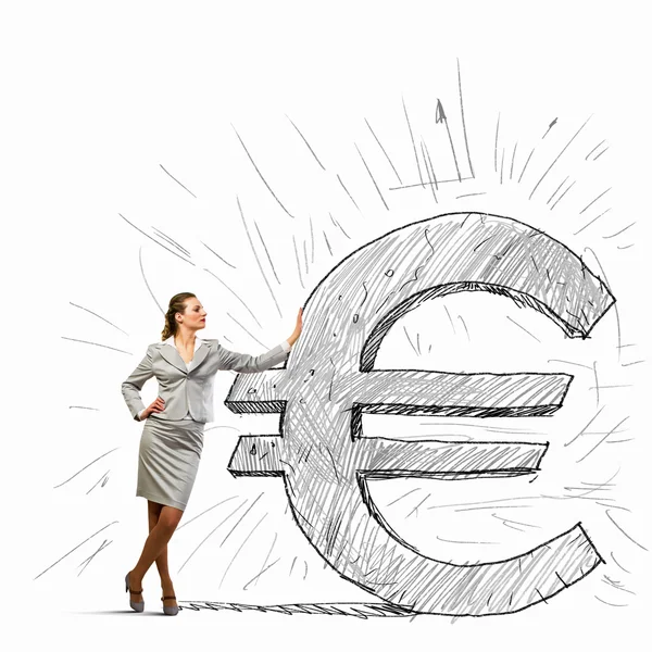 Businesswoman leaning on euro sign — Stock Photo, Image