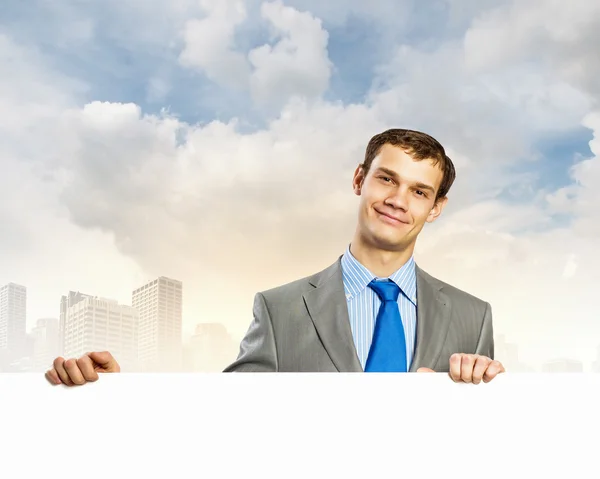 Businessman with blank banner — Stock Photo, Image