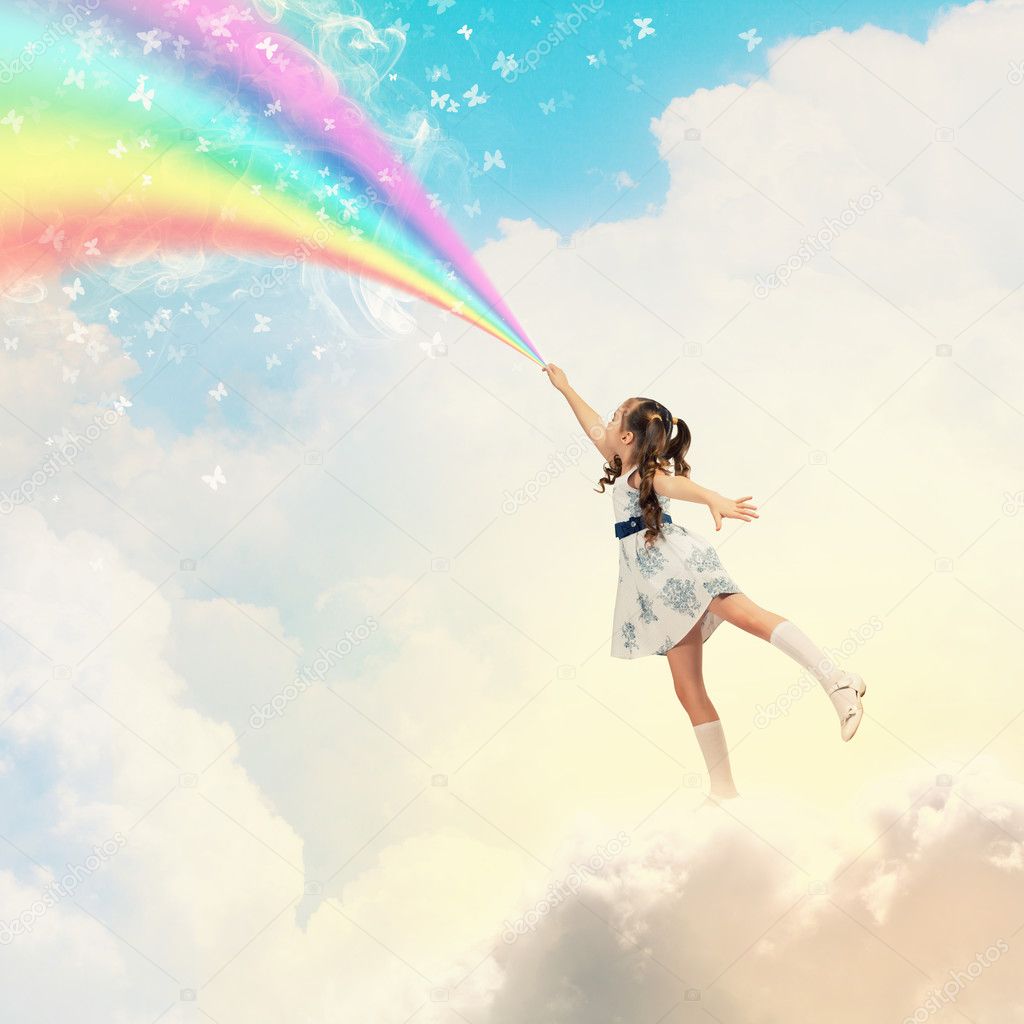 Little girl drawing rainbow