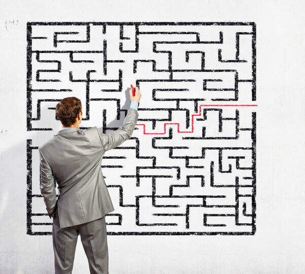 Businessman solving labyrinth problem