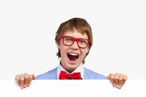 Boy in red glasses holding white square — Stock Photo, Image