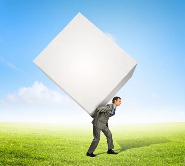 Businessman carrying cube — Stock Photo, Image