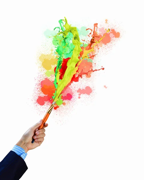 Human hand holding paint brush — Stock Photo, Image