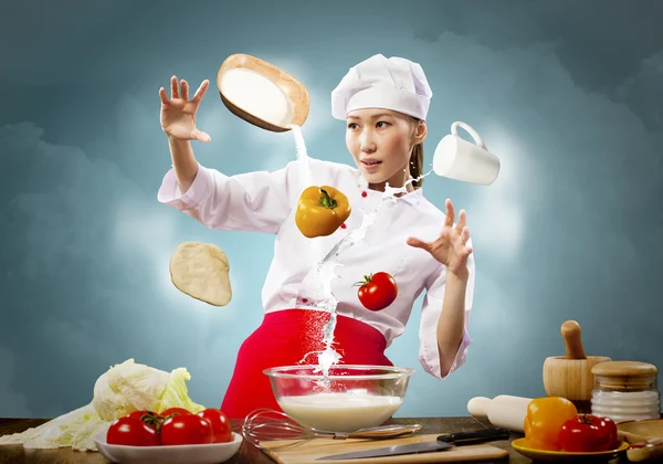 Asian female cooking with magic — Stock Photo, Image