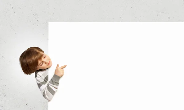 Boy with a blank billboard — Stock Photo, Image