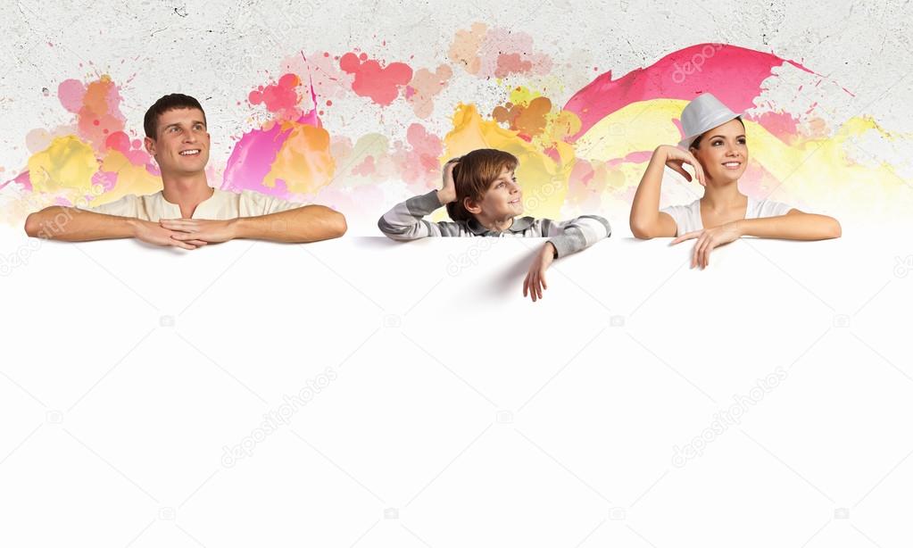 Happy young family with blank banner