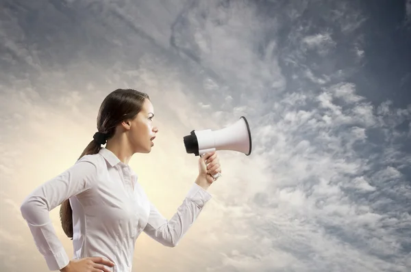 Businesswoman screaming in megaphone — Stock Photo, Image