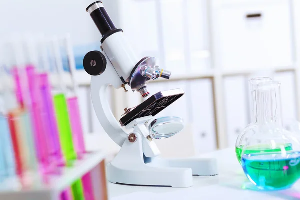 Chemistry laboratory glassware with colour liquids — Stock Photo, Image