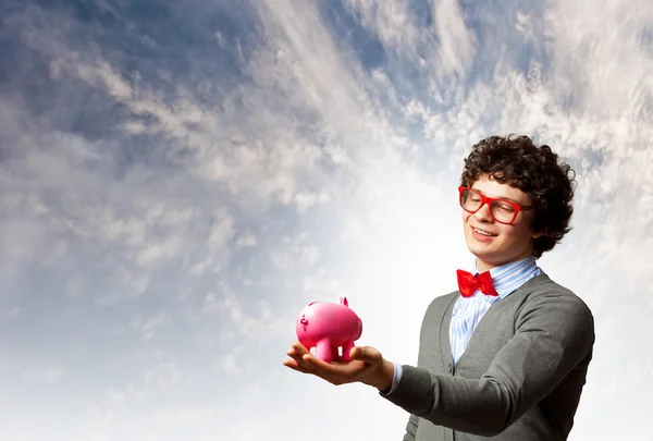 Young businessman holding moneybox — Stock Photo, Image