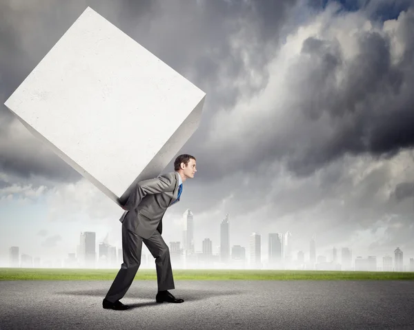 Businessman carrying cube — Stock Photo, Image