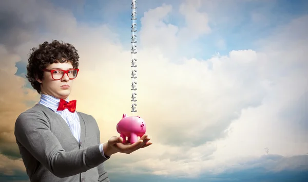 Young businessman holding moneybox — Stock Photo, Image