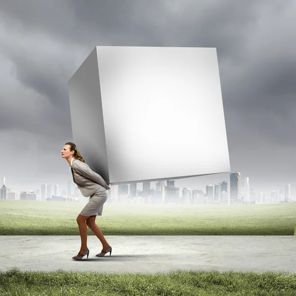 Businesswoman carrying cube — Stock Photo, Image