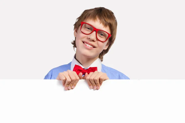 Boy in red glasses holding white square — Stock Photo, Image