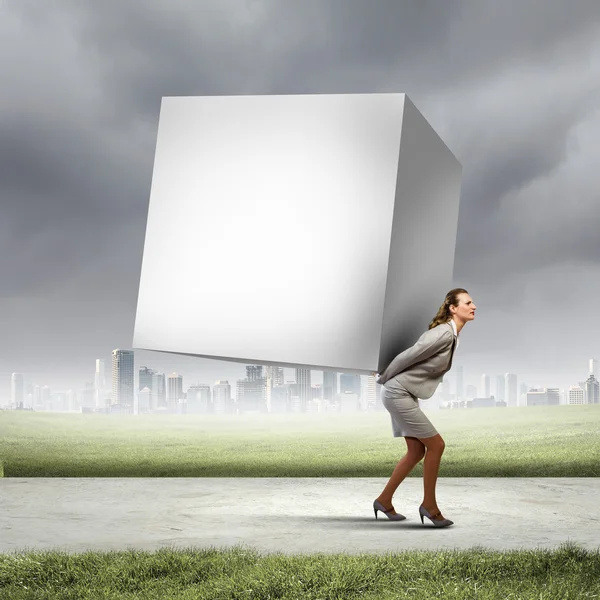 Businesswoman carrying cube — Stock Photo, Image
