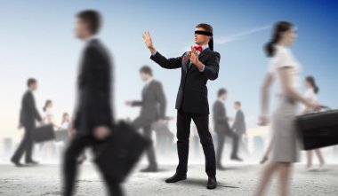 Businessman in blindfold among group of people clipart