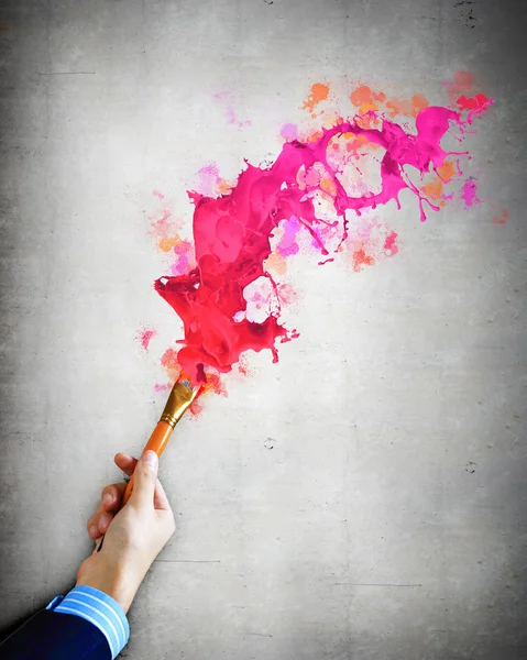 Human hand holding paint brush — Stock Photo, Image