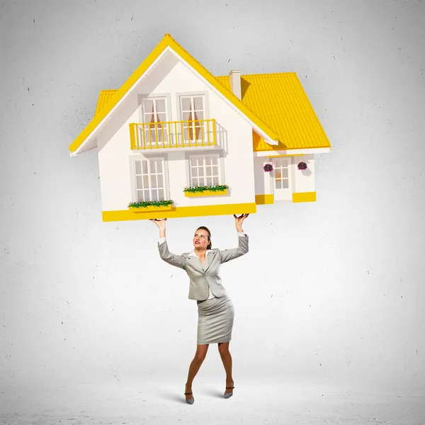 Businesswoman holding model of house — Stock Photo, Image