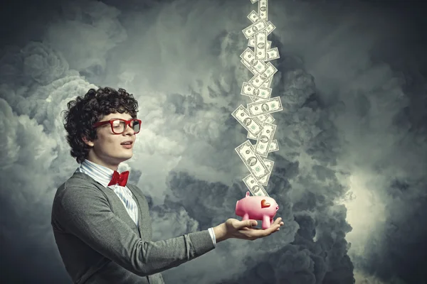 Young businessman holding moneybox — Stock Photo, Image