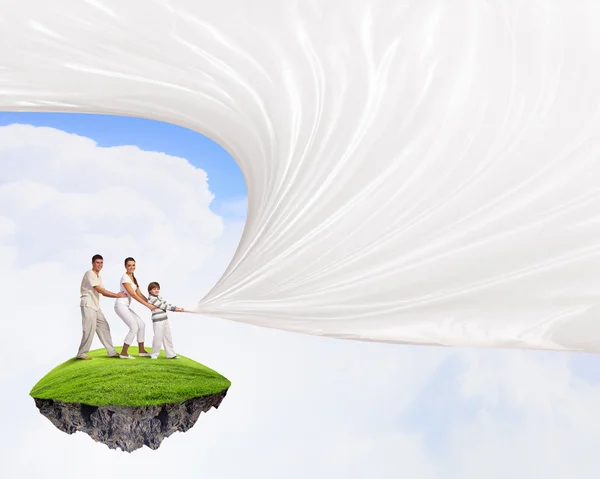 Young family pulling banner — Stock Photo, Image