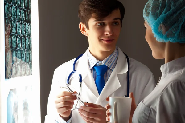 Two doctors examining x-ray results — Stock Photo, Image