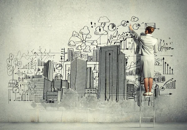 Businesswoman drawing on wall — Stock Photo, Image