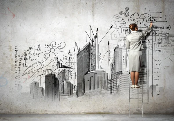 Businesswoman drawing on wall — Stock Photo, Image