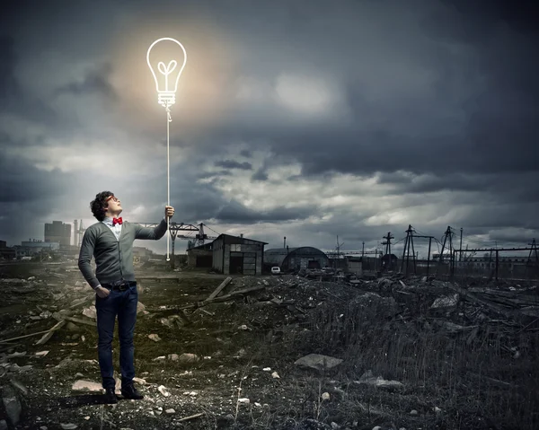 Young man holding a light — Stock Photo, Image