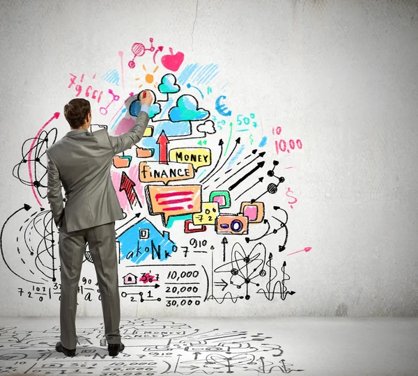 Empresario dibujando bocetos en la pared — Foto de Stock