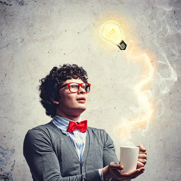 Young man with an electric bulb — Stock Photo, Image