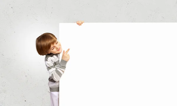 Boy with a blank billboard — Stock Photo, Image