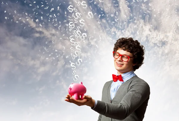 Young businessman holding moneybox — Stock Photo, Image