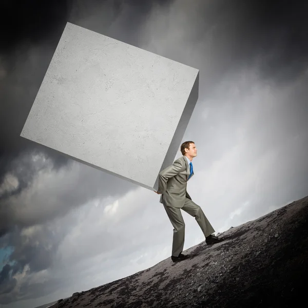 Businessman carrying cube — Stock Photo, Image