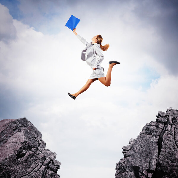 Young businesswoman jumping