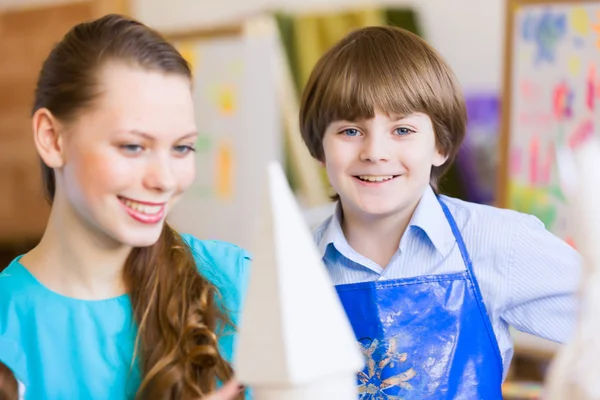 Children painting with teacher — Stock Photo, Image