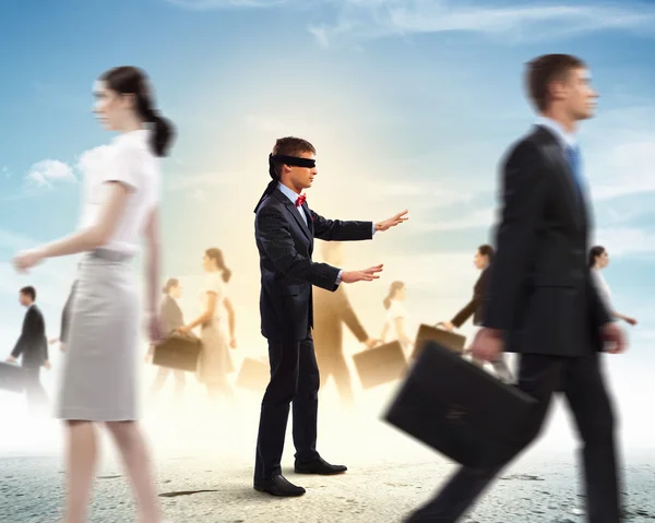 Businessman in blindfold among group of people — Stock Photo, Image