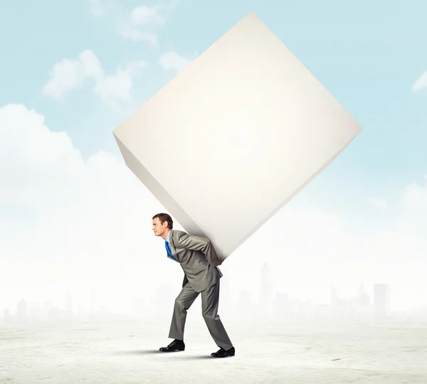 Businessman carrying cube — Stock Photo, Image