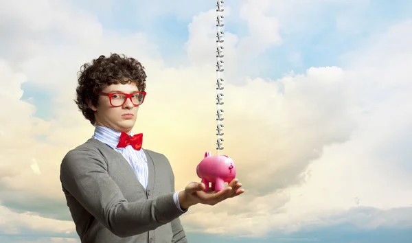 Young businessman holding moneybox — Stock Photo, Image