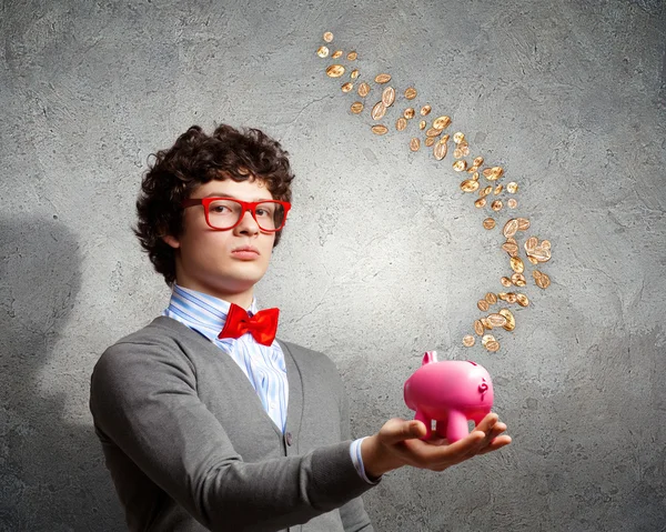 Young businessman holding moneybox — Stock Photo, Image