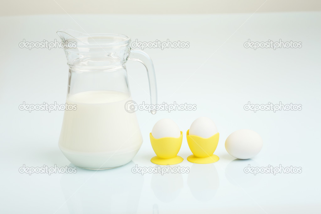 Milk in a glass jar and eggs