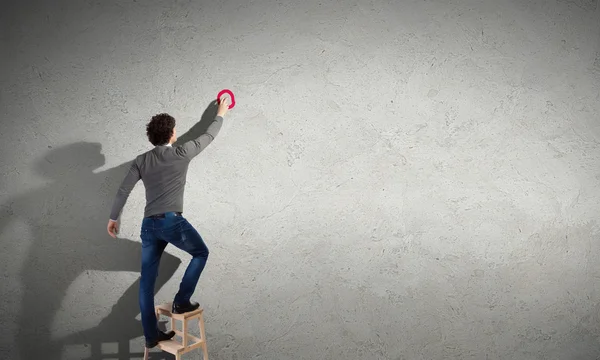 Young man standing near the wall — Stock Photo, Image