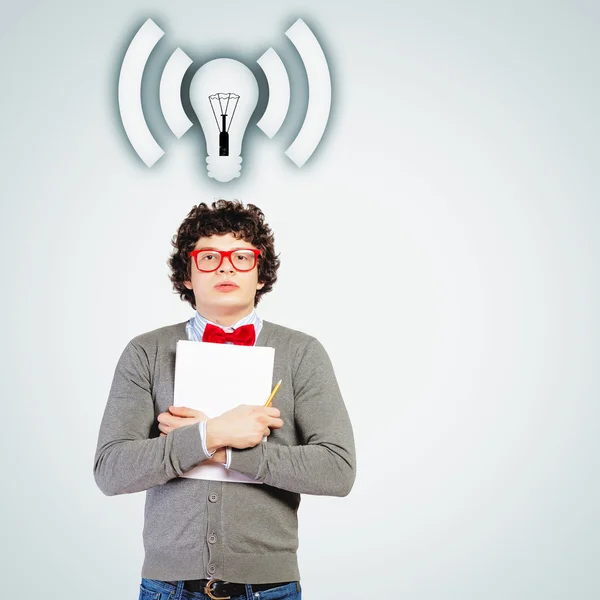 Young man with papers and light bulb — Stock Photo, Image