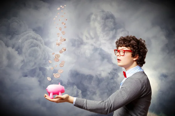 Young businessman holding moneybox — Stock Photo, Image