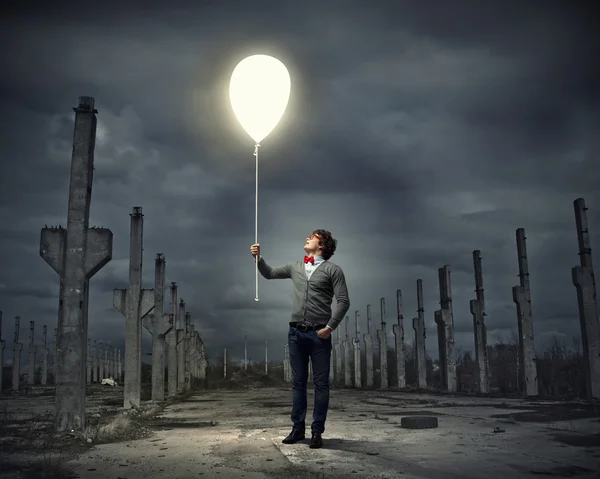 Young man holding a light — Stock Photo, Image