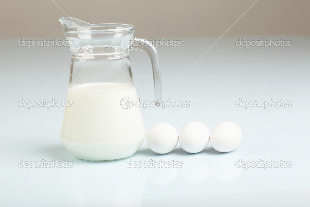 Milk in a glass jar and eggs