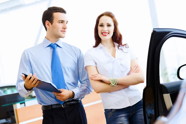 Young woman at car salon — Stock Photo, Image