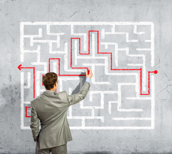 Businessman solving labyrinth problem