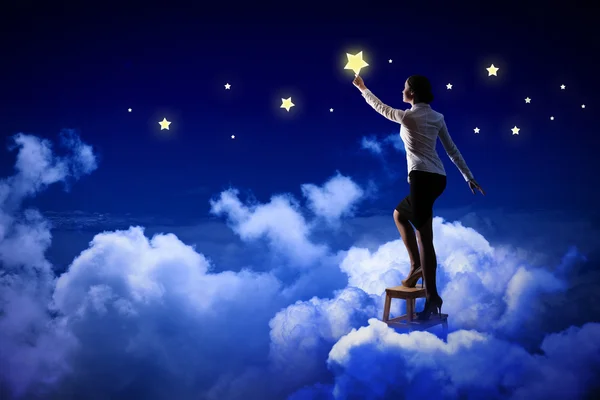 Woman lighting stars — Stock Photo, Image